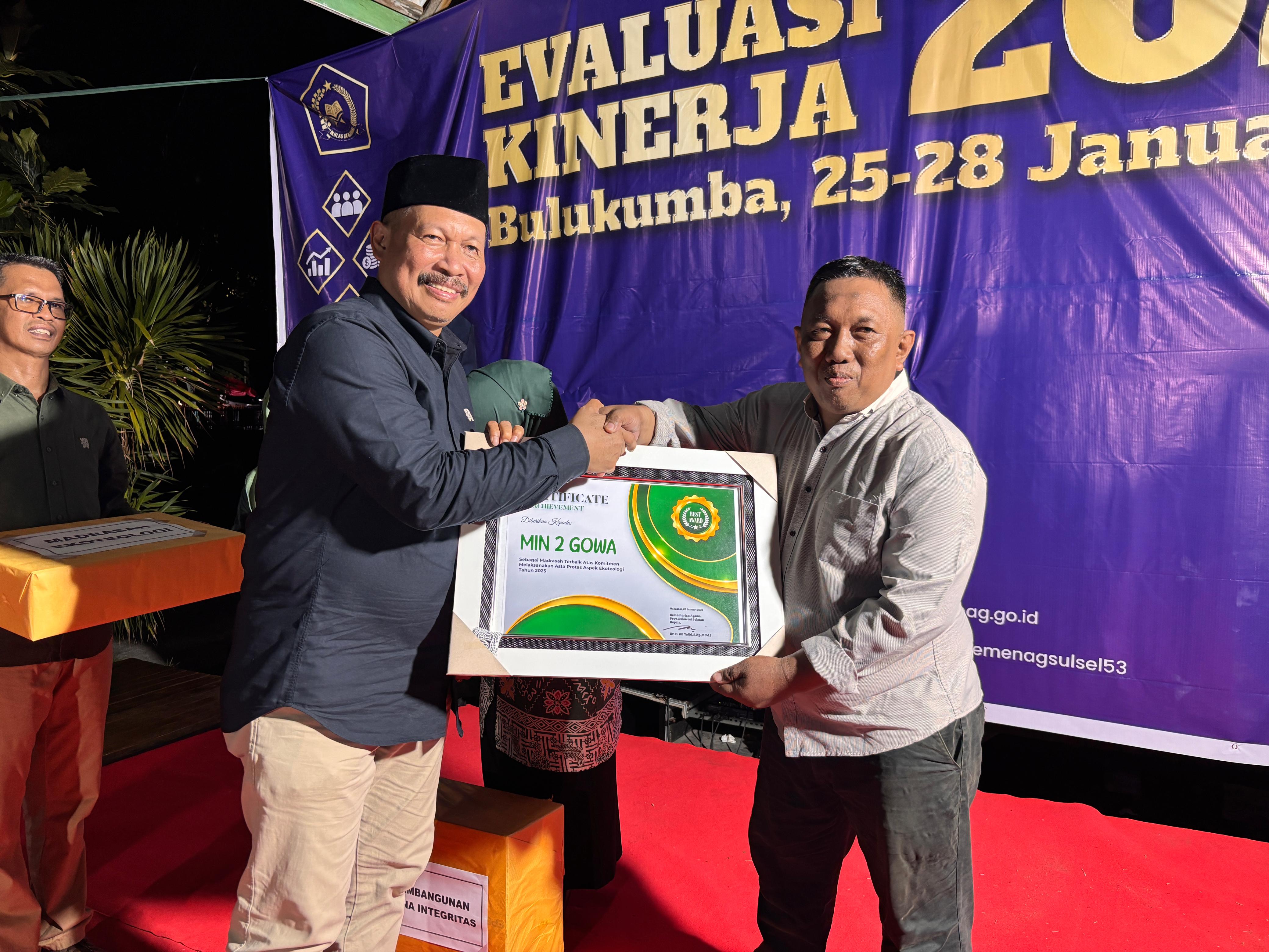 Kepala madrasah saat menerima penghargaan