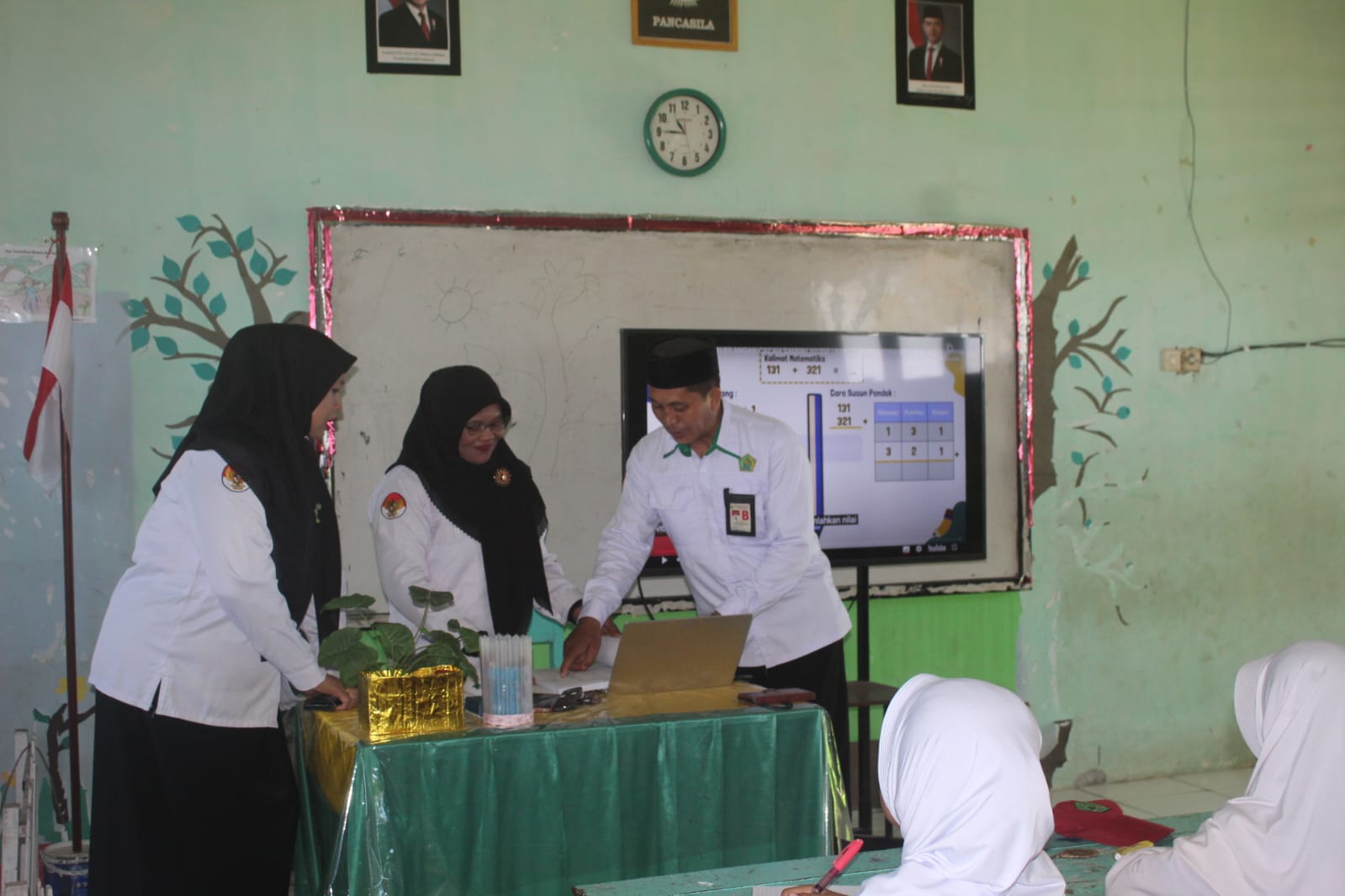 Abdul Latif (kanan) didampingi Asti Yuliarni (kiri) melakukan pemantauan proses pembelajaran